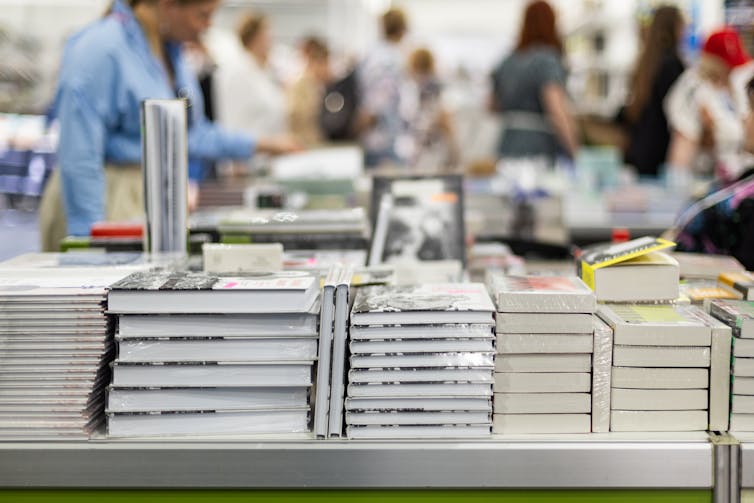 Books stacked on a display table in a bookstore