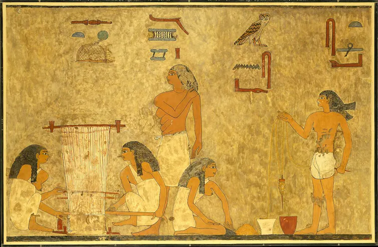 Scene of four weavers and an overseer, two figures are plying thread on the left, and two figures are working a ground loom