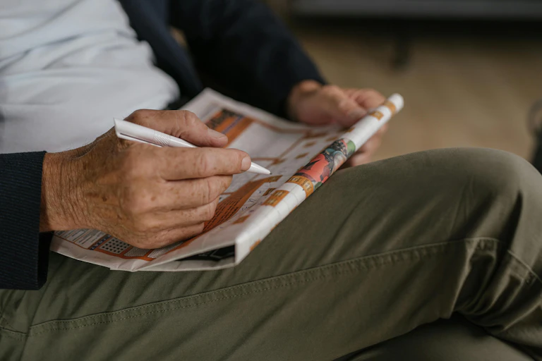 Older man does a crossword puzzle