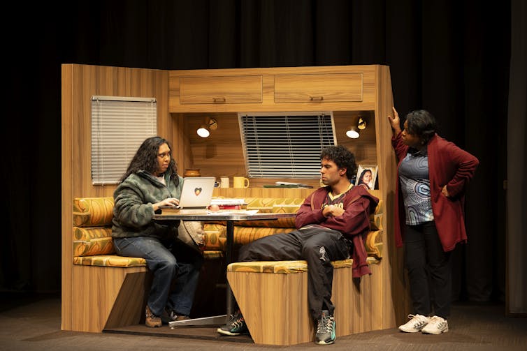 Production image: the family gathers in a caravan.