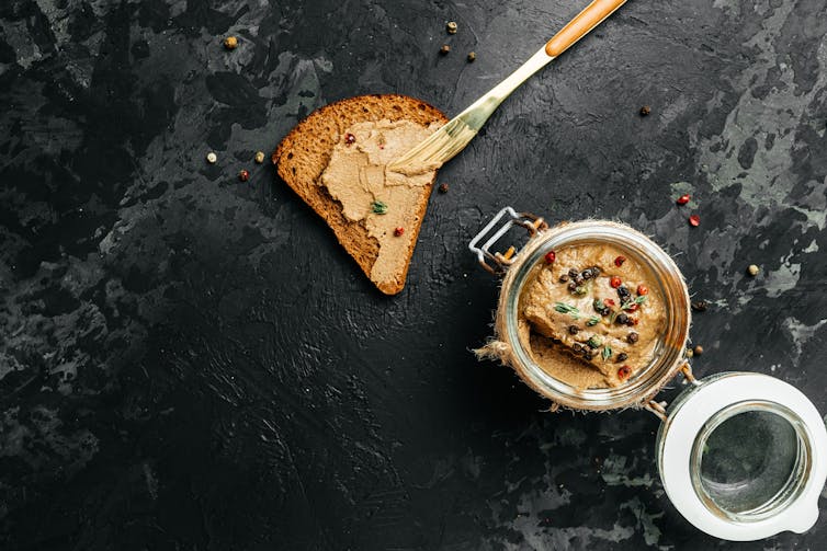 A dish of foie gras and a triangle of toast.