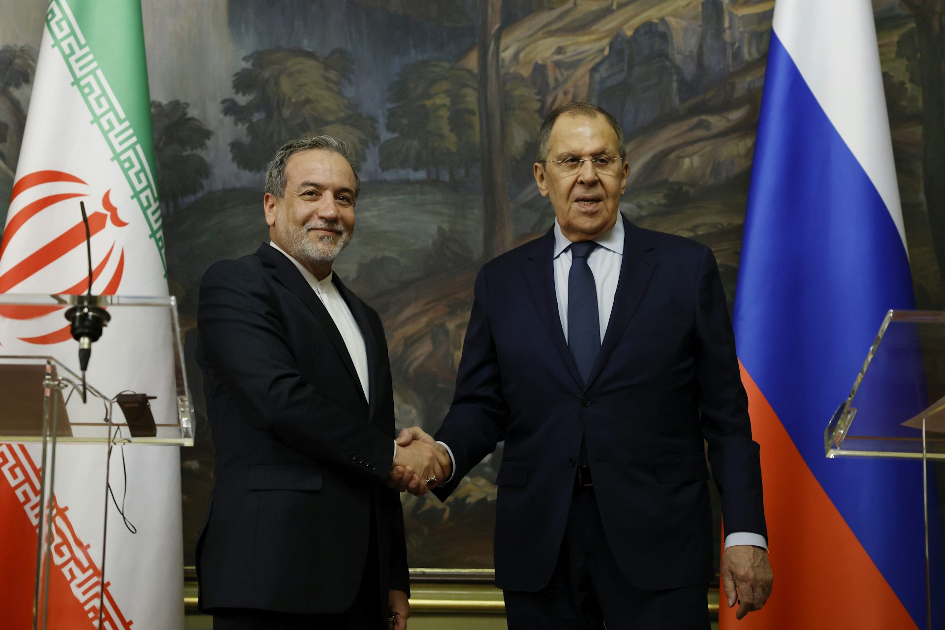 Russia's foreign minister, Sergei Lavrov, shakes hands with his Iranian counterpart, Abbas Araghchi.
