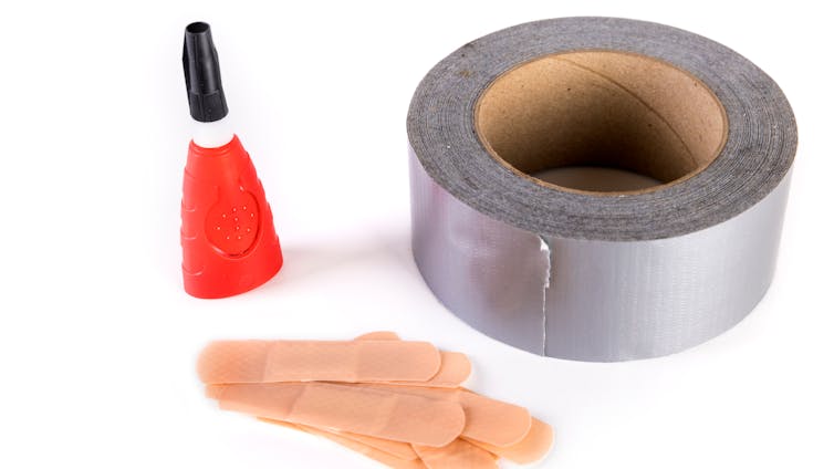 Image of bottle of superglue, roll of gaffer tape and some plasters