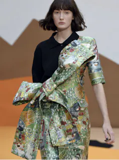 A model in a silk dress made from a Moomin pattern.