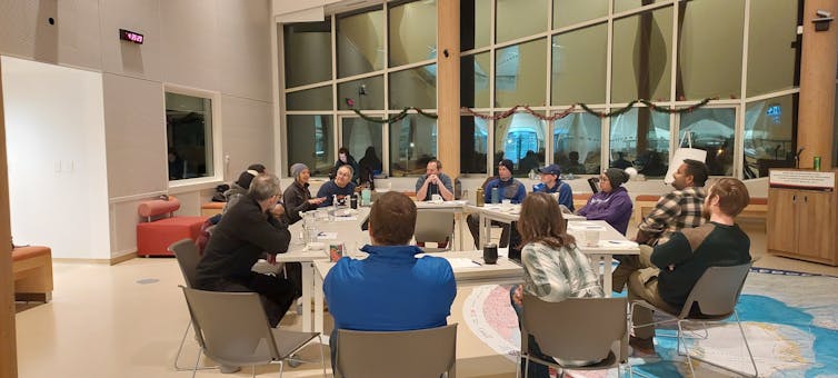 A group of people sits around a large table