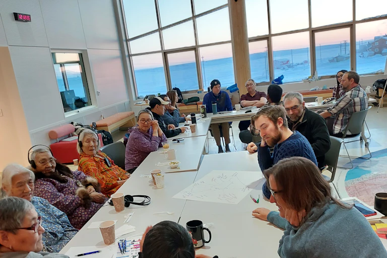 Indigenous Elders from the Kitikmeot Heritage Society, community members, hunters and trappers, regional tourism representatives, and scientists engage in an open conversation about integrating genomics with traditional knowledge for muskox co-management.