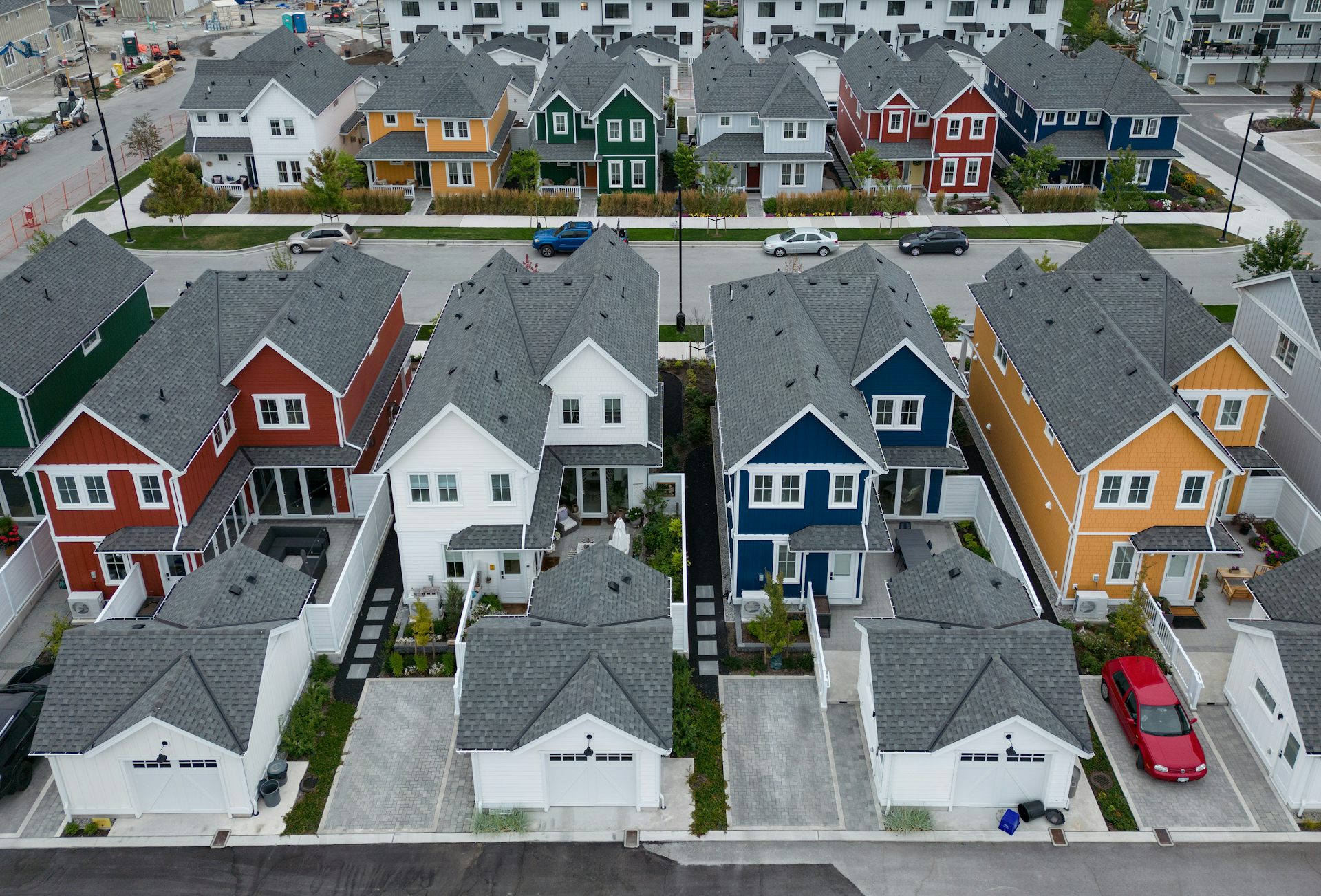 A row of different coloured houses on a residential street