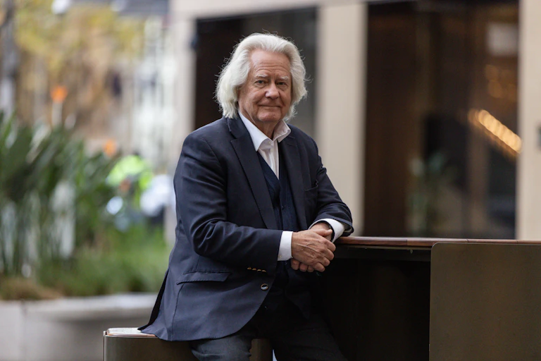 A grey haired man in a blue suit: A.C. Grayling.