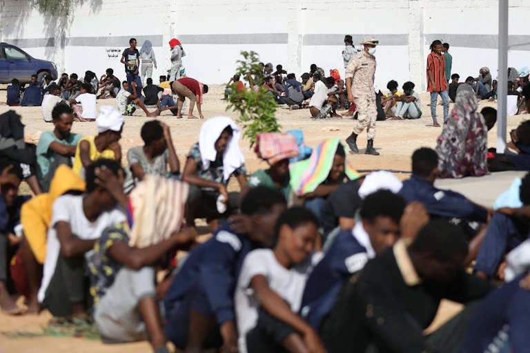 Migrants sat inside the Ain Zara detention centre in Tripoli, Libya.