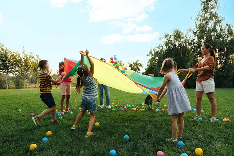 Children and teacher playing outdoors