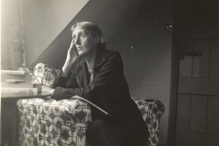 Virginia Woolf in a black and white photograph, looking wistful