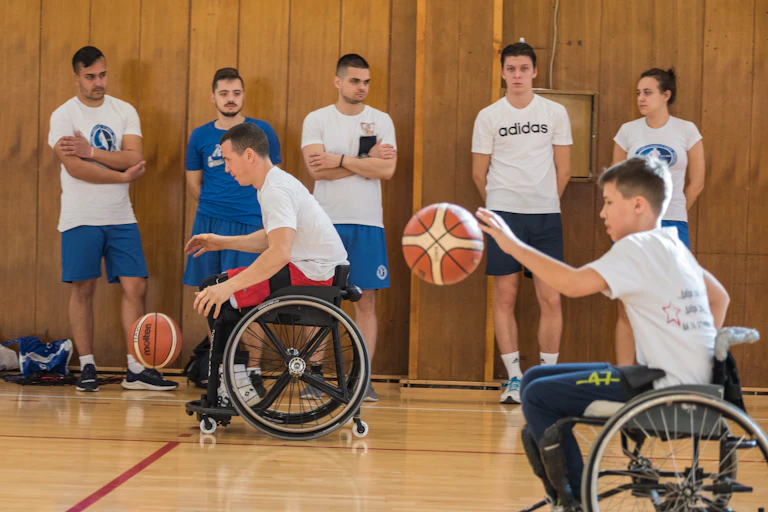 Wheelchair basketballers enjoy a game in a gym
