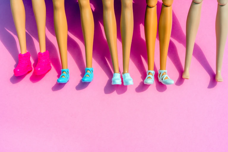 Rows of Barbie doll legs with flat shoes