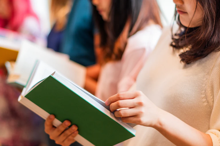 Group of people reading books.