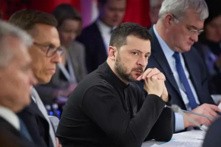 President Zelensky leaning on his hands.