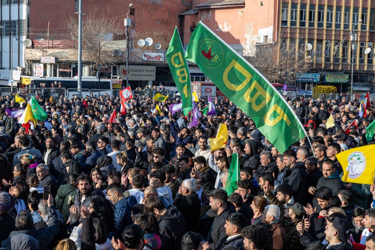 Why are Turkey and the PKK turning to peace – and will it ultimate? 2 A crowd of Kurds waving green and yellow flags.