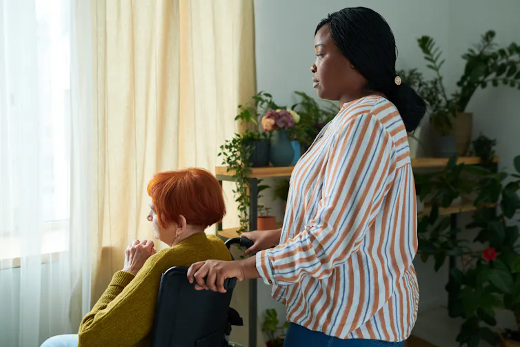 female care worker with a disabled woman in a wheelchair
