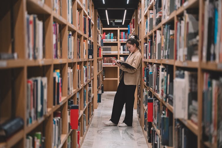 Student in library stacks