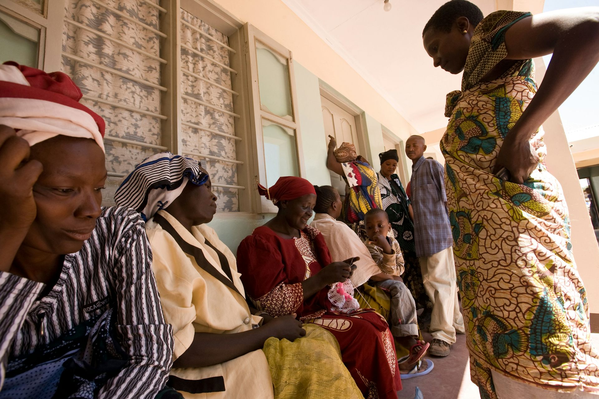 People wait in line at a clinic. 