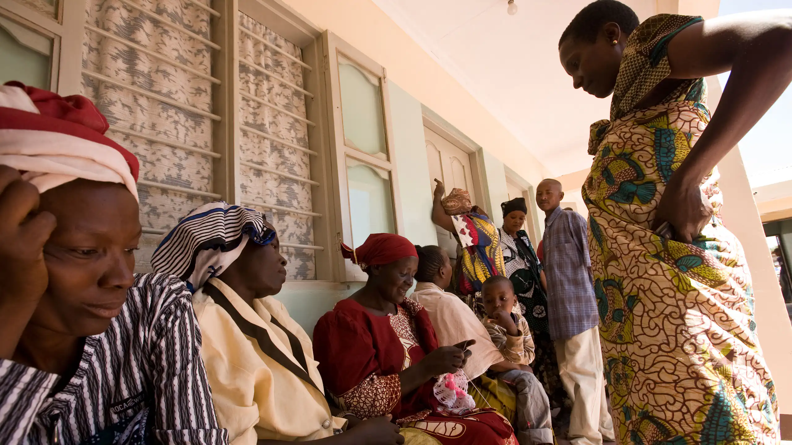 People wait in line at a clinic.