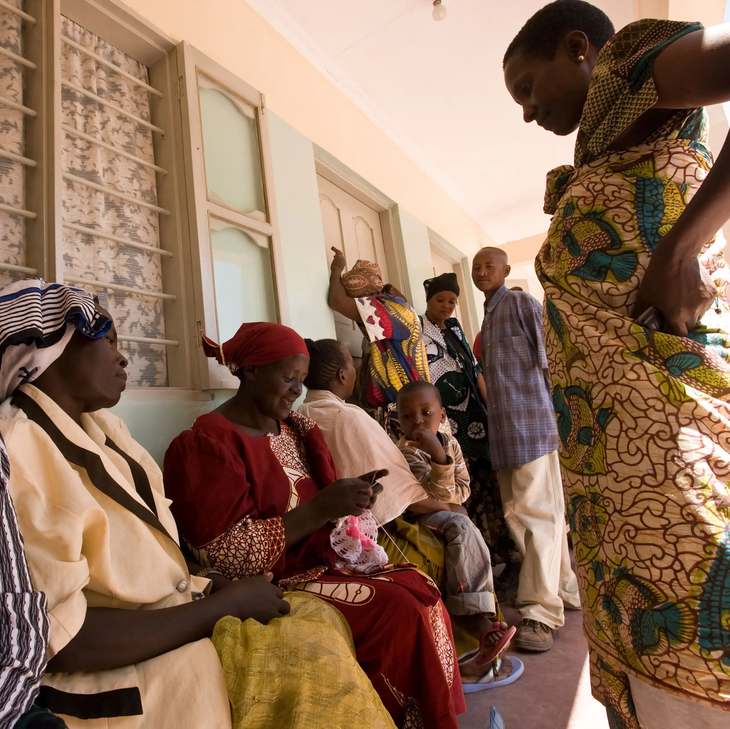 People wait in line at a clinic.