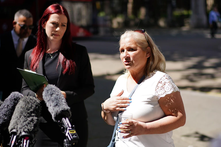 Two women speaking to the media outside a court.