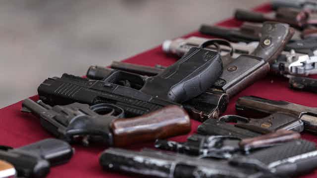 cybersecurity expert Guns on a table in Mexico.