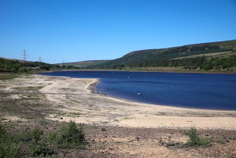 A reservoir with a large, dry bank.