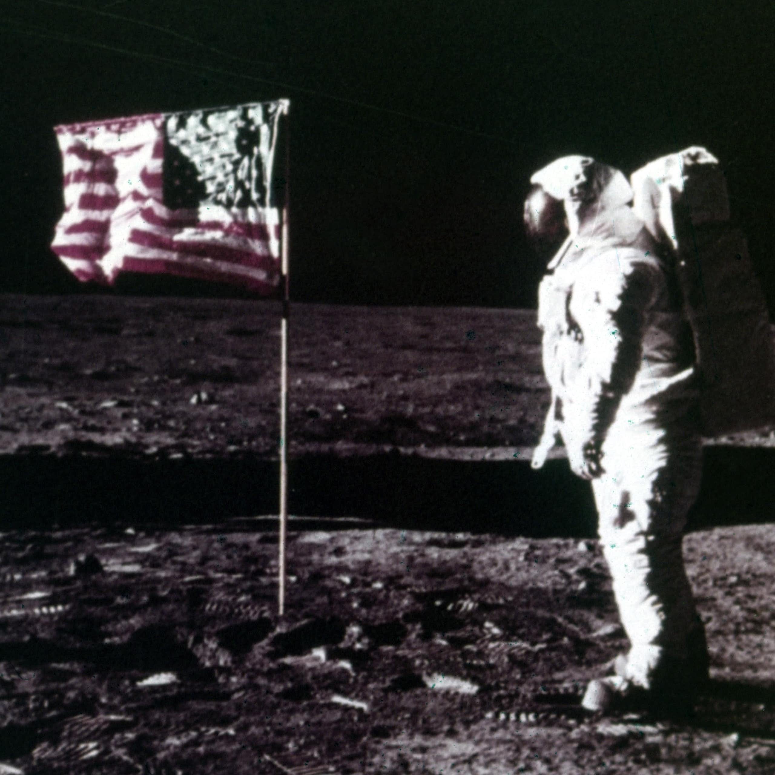 Buzz Aldrin stands next to the American flag on the surface of the Moon, Apollo 11 mission, July 1969.