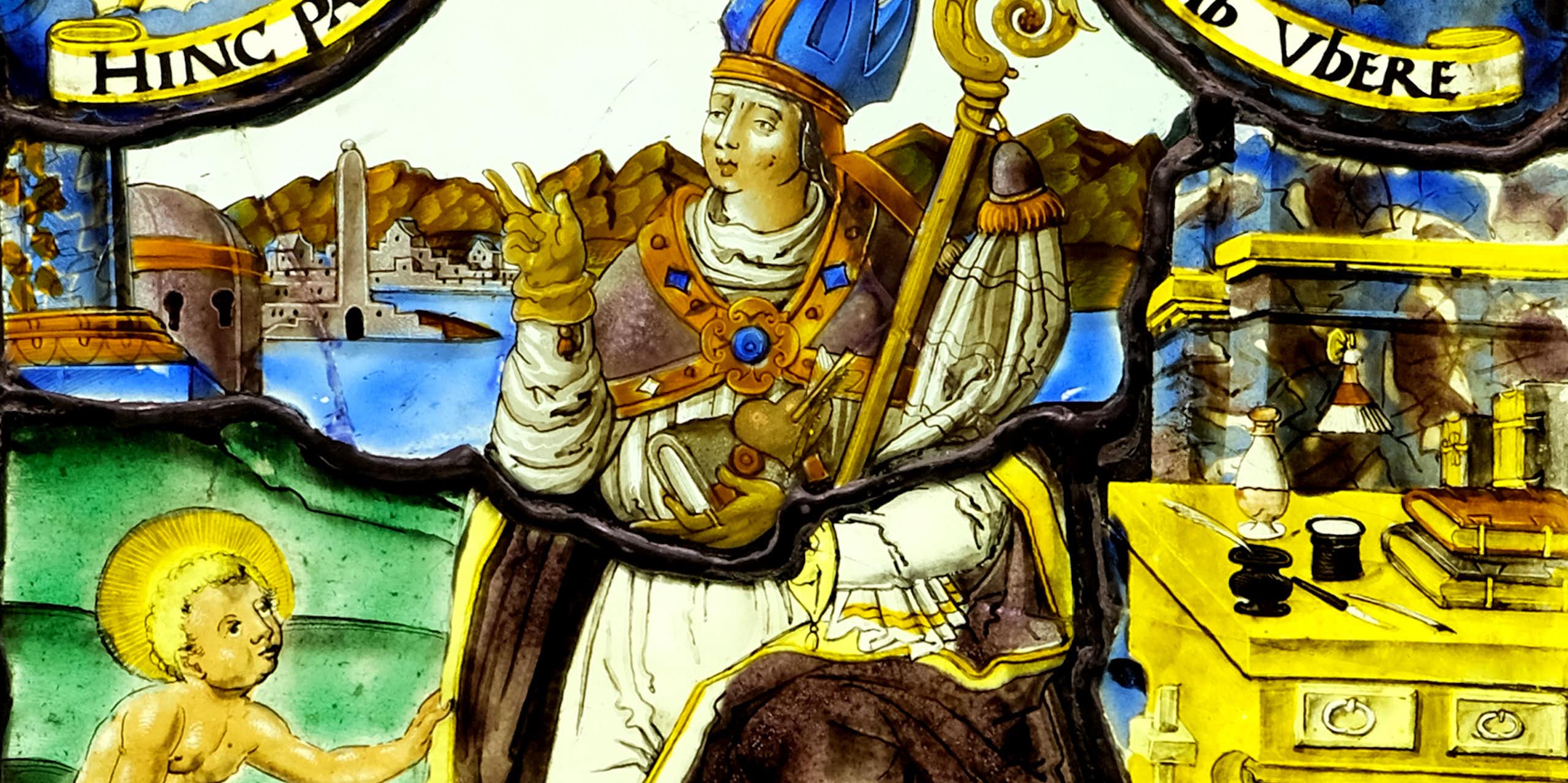 A man wearing a crown sitting on a chair with a child by his feet.