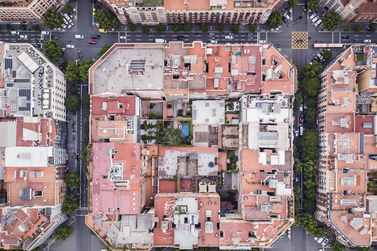 drone shot looking down to blocks of buildings, square rounds surrounding them