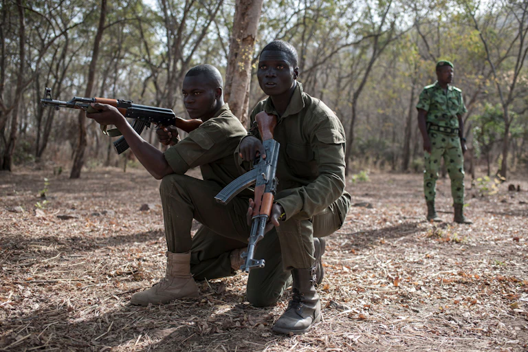 Men in military uniform, holding rifles