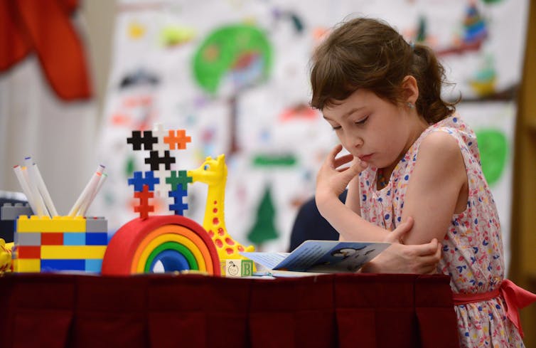 A child bent over a book.