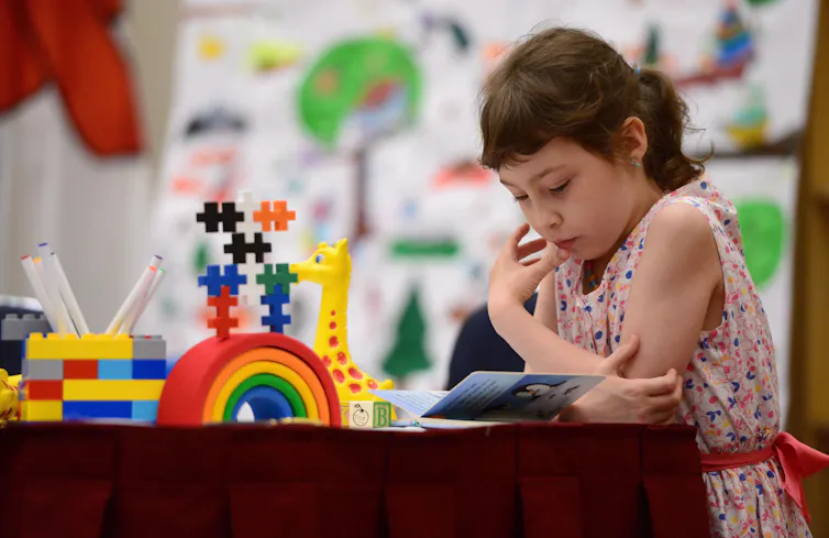A child bent over a book.
