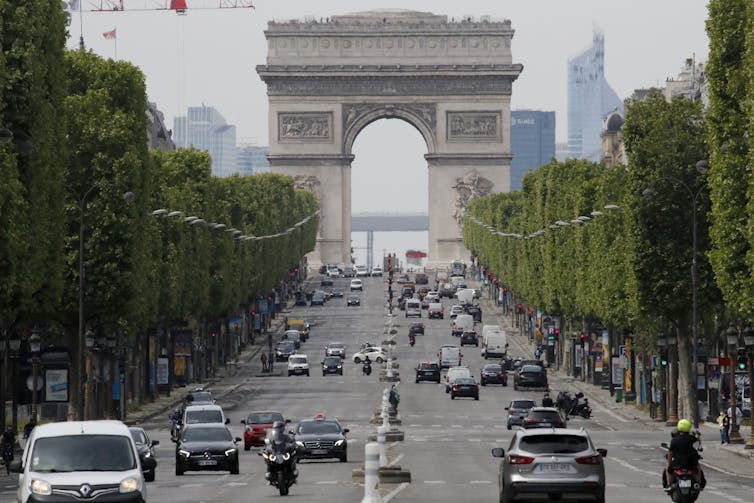 Cars driving on a road in Paris.