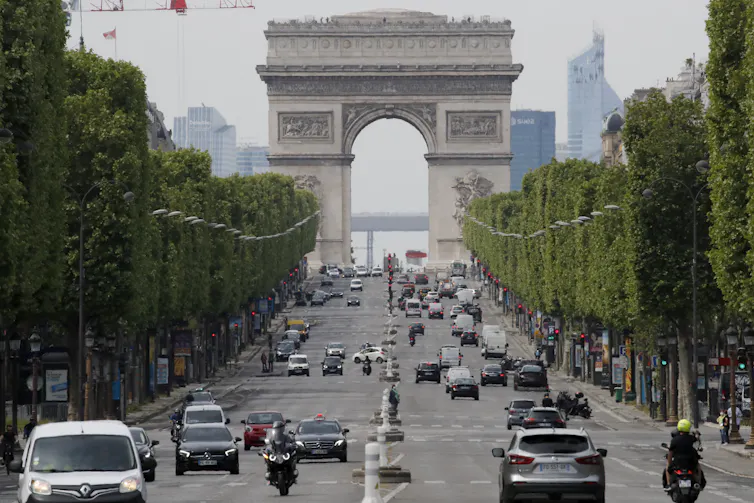 Cars driving on a road in Paris.