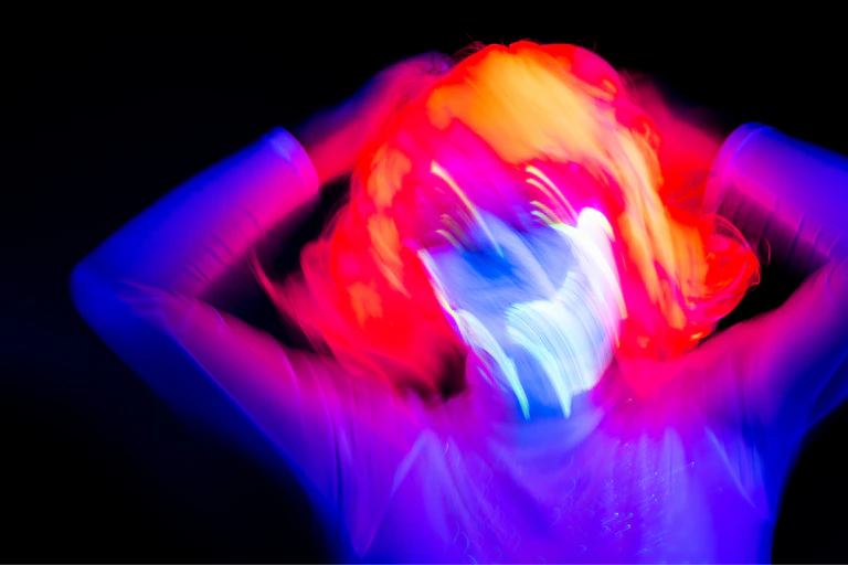 A woman clutches her head