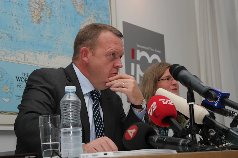Danish foreign minister Lars Løkke Rasmussen at a bank of microphones.