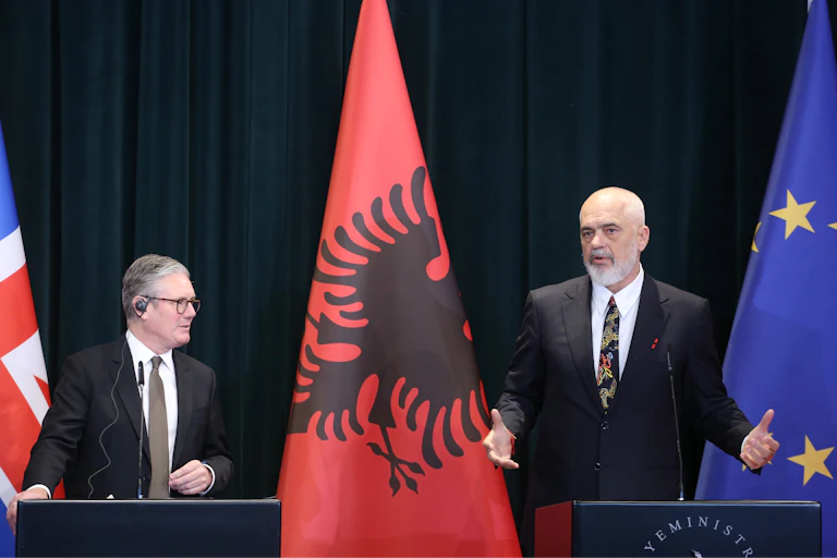 Keir Starmer and Edi Rama speaking side by side at podiums, with a UK, Albania and EU flags in the background