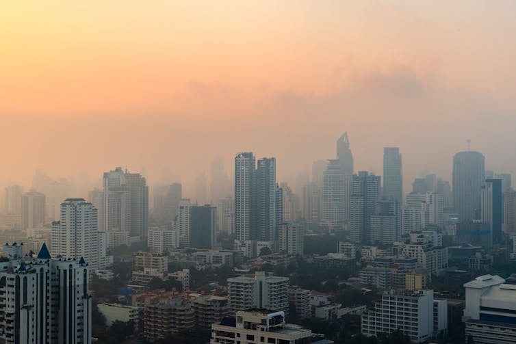 A picture of a cityscape with pollution causing hazy in the air.