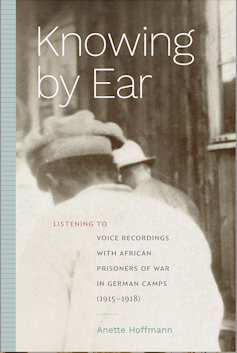 A book cover showing an old sepia image of the back of an African man as he walks, head bowed, led by a man in a military helmet.