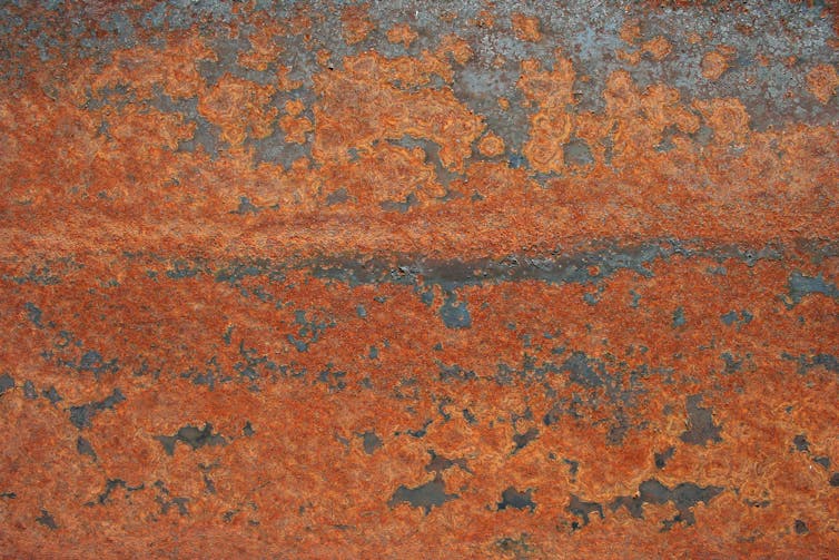 Rust flakes on metal.