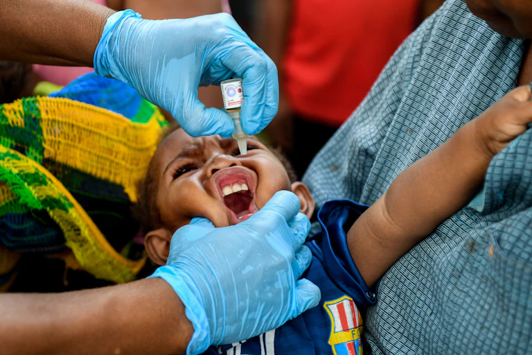 A child receives the oral polio vaccine.