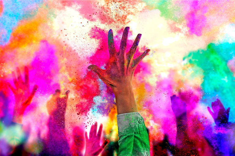 Close up of hand with background of clouds of colour