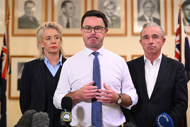 David Littleproud stands and frowns during a press conference with Bridget McKenzie and Kevin Hogan behind him