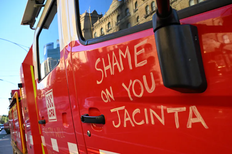 Close up image of a fire truck with writing on the door