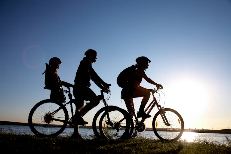 Young family go for a cycle ride on the beach.