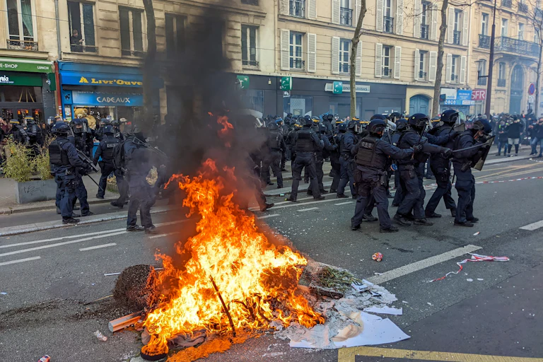 Fire burning in the middle of a street of Paris, France during a protest againt the retirement reform.