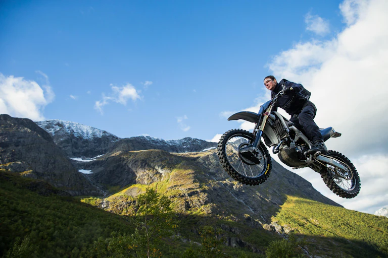 Ton Cruise doing a bike stunt in Mission Impossible – Dead Reckoning