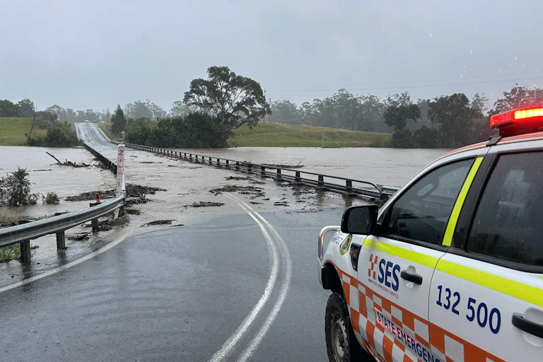 emergency vehicle at flooded bridge